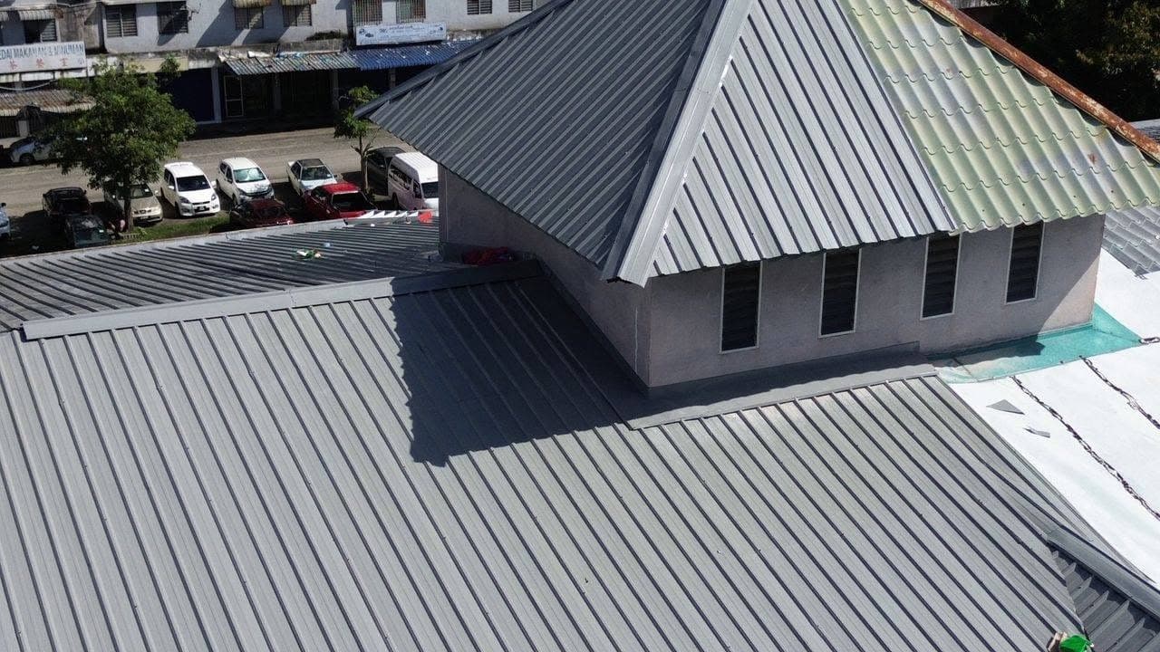 Grey metal deck roof upgrade project by One Roof Solutions